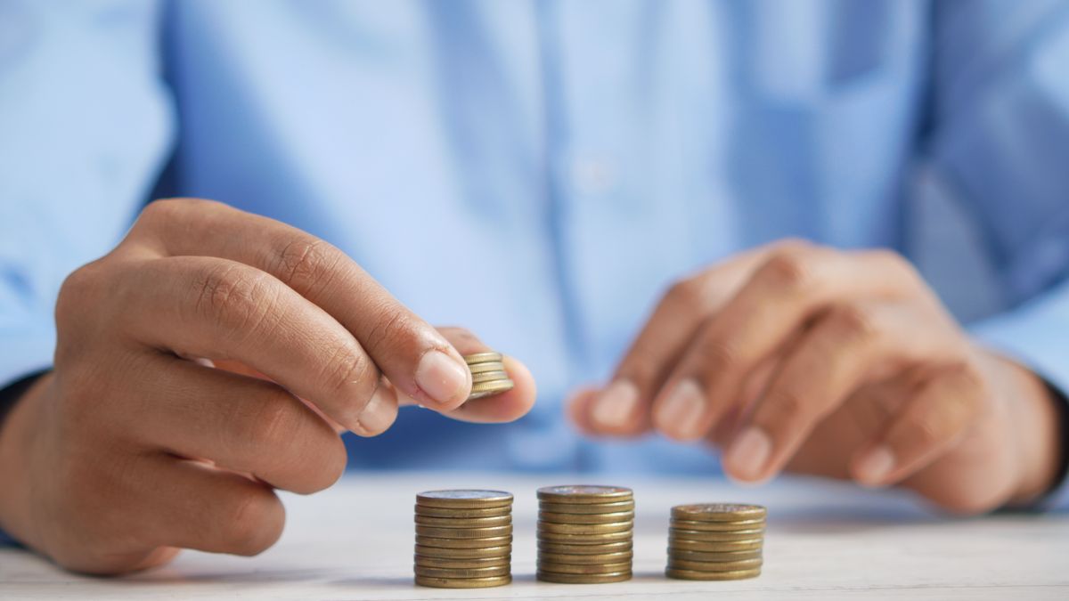 Hands stacking gold coins