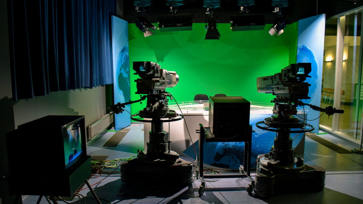 Studio lighting setup with cameras and green screen